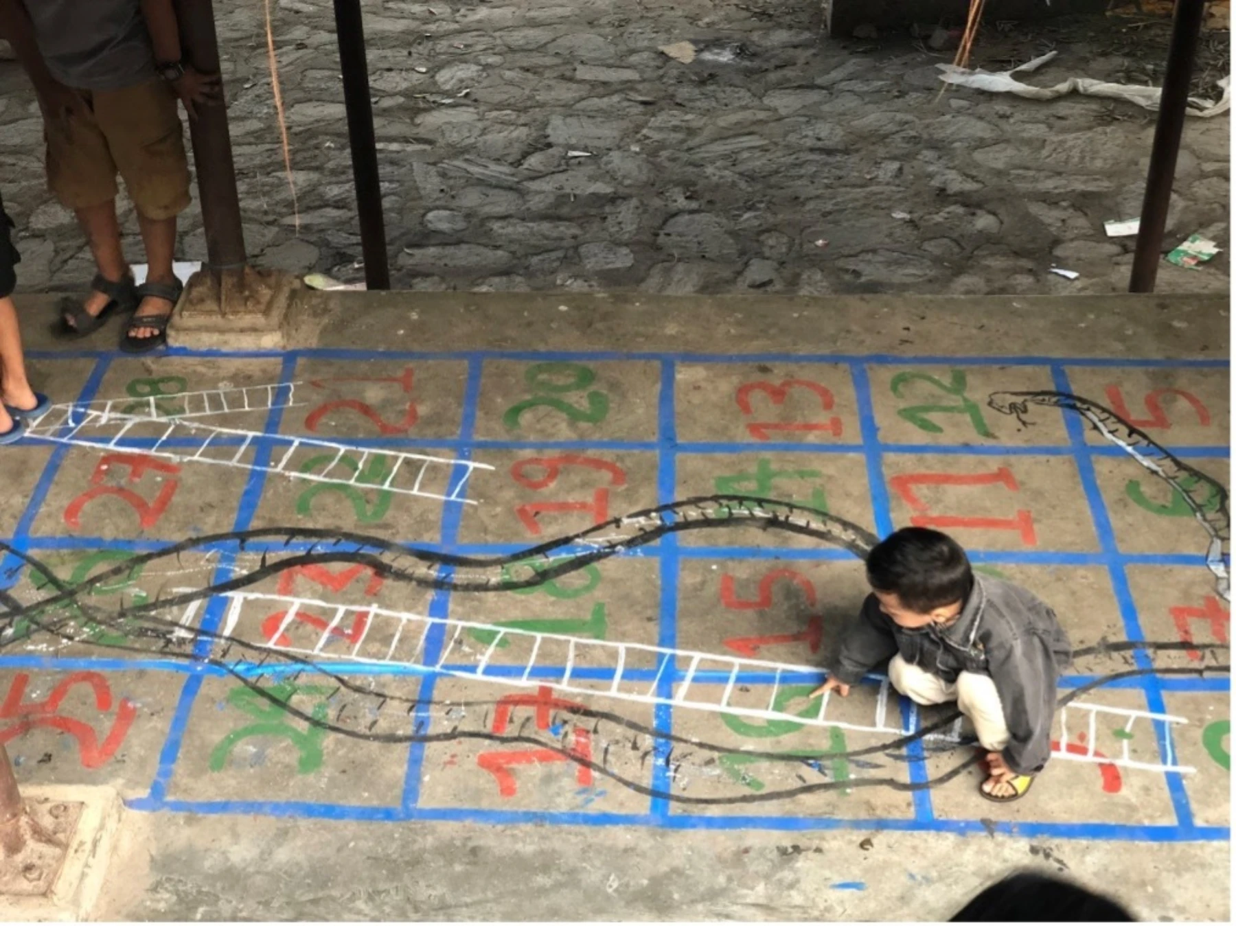 Nepal A kid enjoying the game boards on their way through the weekly market area