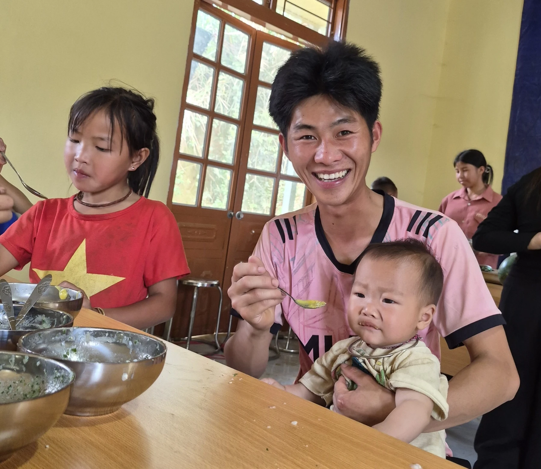 Mr Tro is feeding his child Son La